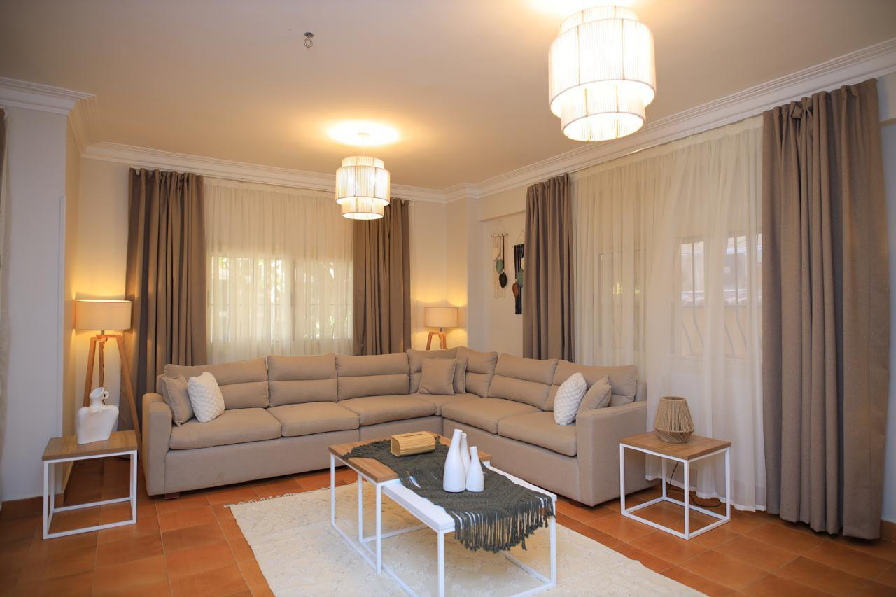 Modern corner sofa made of red beech wood and linen