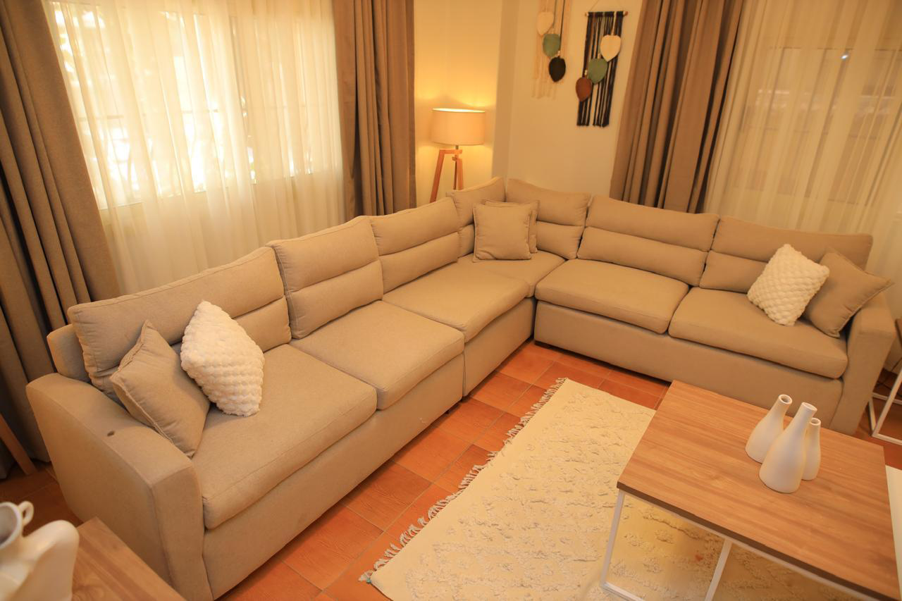 Modern corner sofa made of red beech wood and linen